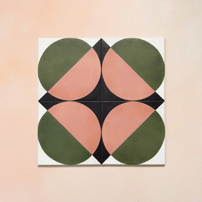 Group image showing four Geometry Moon 20x20cm geometric patterned tiles arranged to form a circular motif, featuring green and terracotta semicircles with black and cream corner details, photographed against a soft peach-toned background.