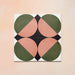 Group image showing four Geometry Moon 20x20cm geometric patterned tiles arranged to form a circular motif, featuring green and terracotta semicircles with black and cream corner details, photographed against a soft peach-toned background.