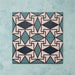 Group image showing four Geometry Iris 20x20cm patterned tiles arranged to form a continuous geometric motif in teal, navy, terracotta-red, and cream, photographed against a soft mottled aqua background.