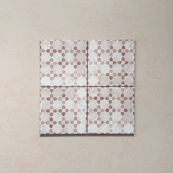 Composición de cuatro azulejos de estilo marroquí Bedouin Mequinez Rosa 15x15 cm colocados juntos, mostrando el diseño geométrico repetido en tonos rosa empolvado, beige y blanco con acabado mate artesanal y textura sutil.