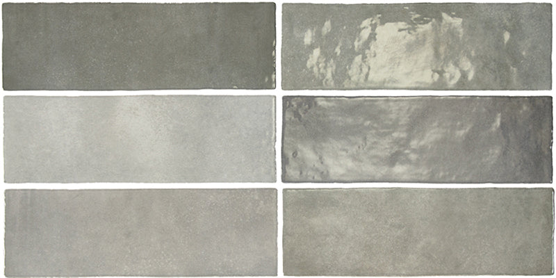 Vista cenital de azulejos de pared cerámicos Zellij Gris Ladrillo 6,5 × 20 cm de estilo marroquí, dispuestos en un patrón desplazado, mostrando una suave variación tonal en gris, un acabado brillante de aspecto artesanal y bordes ligeramente irregulares.