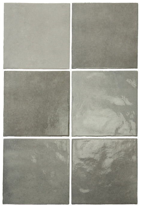 Vista cenital de azulejos de pared cerámicos Zellij Gris Cuadrado 13,2 × 13,2 cm de estilo marroquí, dispuestos para destacar la suave variación tonal en gris, el acabado brillante de aspecto artesanal y los bordes sutilmente irregulares para un aspecto auténtico y lleno de carácter.