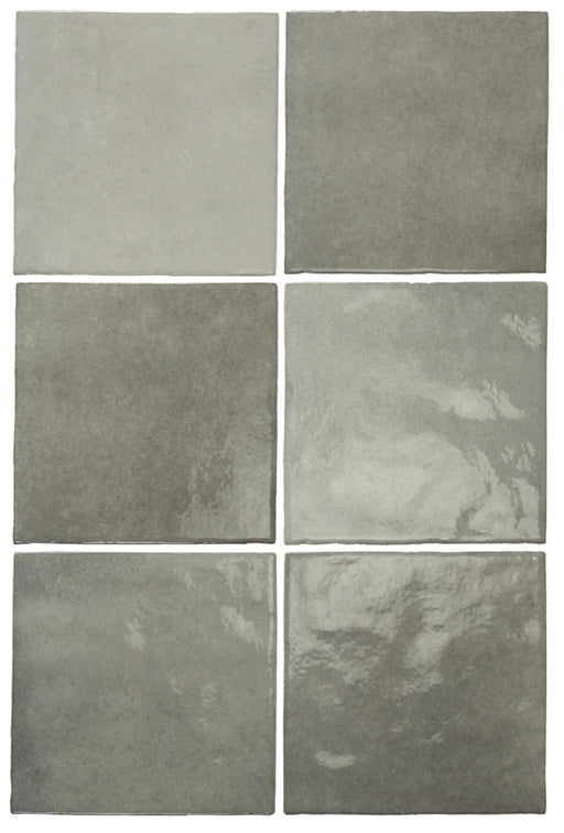 Vista cenital de azulejos de pared cerámicos Zellij Gris Cuadrado 13,2 × 13,2 cm de estilo marroquí, dispuestos para destacar la suave variación tonal en gris, el acabado brillante de aspecto artesanal y los bordes sutilmente irregulares para un aspecto auténtico y lleno de carácter.
