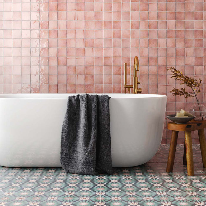 Bathroom featuring Fizaan Festive Blue 20x20cm Moroccan-style porcelain floor tiles, styled with a freestanding white bath, brass fittings and decorative geometric patterns for a bold, characterful look.