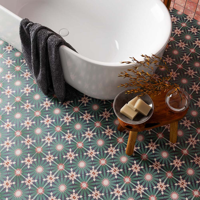 Bathroom featuring Fizaan Festive Blue 20x20cm Moroccan-style porcelain floor tiles, styled with a freestanding white bath, brass fittings and decorative geometric patterns for a bold, characterful look.