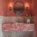 Azulejos de pared Beijing Rose Pink Brick de 5,1 × 16,1 cm de estilo marroquí, con suaves variaciones de tonos rosa en un baño de ambiente cálido con paredes en color coral, un lavabo de mármol rosa y azulejos decorados en el suelo.