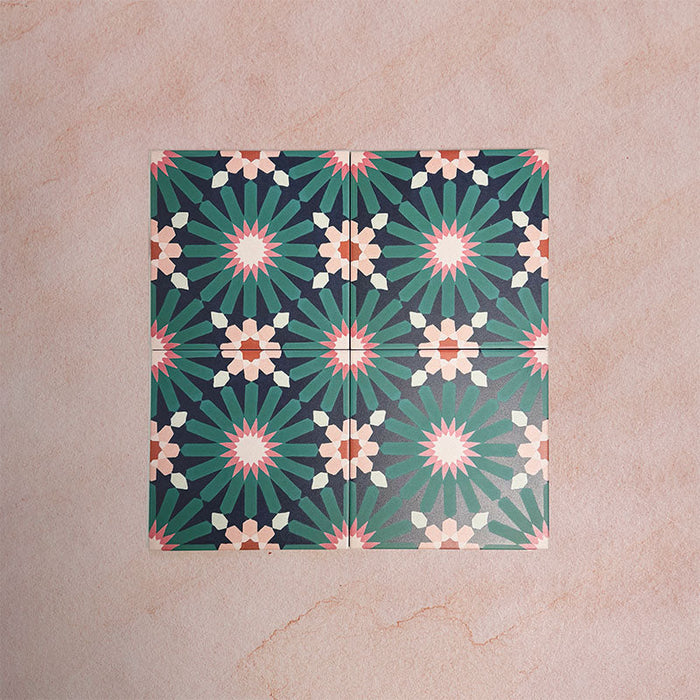 Arrangement of Fizaan Festive Blue 20x20cm Moroccan-style porcelain tiles showcasing a repeating geometric pattern in rich blue, green and soft neutral tones.