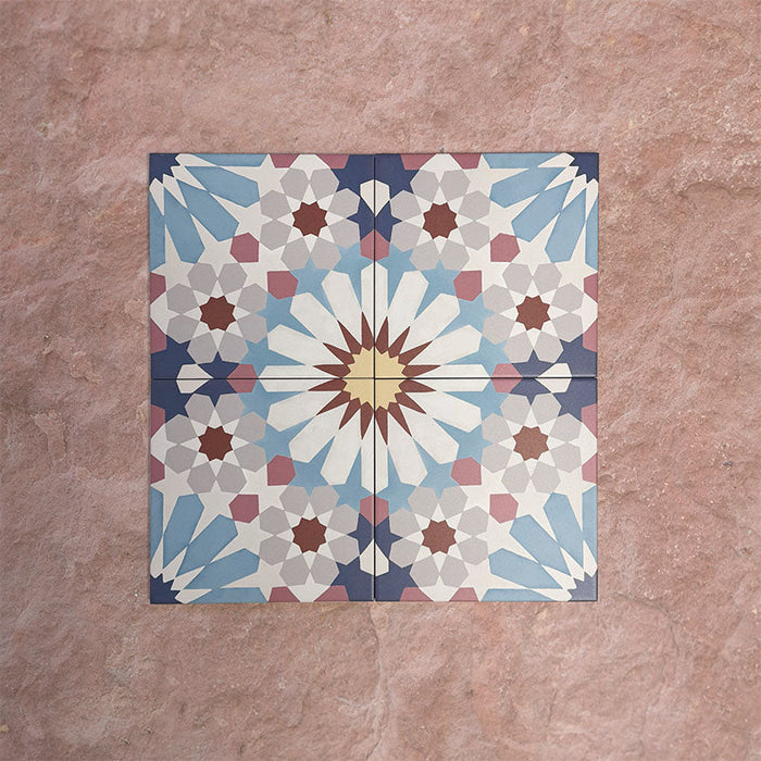 Arrangement of Fizaan Fiera 20x20cm Moroccan-style porcelain tiles, showcasing a repeating geometric pattern in soft blue, red and neutral tones.