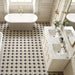 Classic bathroom featuring Kasuf Night 20x20cm terrazzo-style decor floor tiles, styled with a freestanding bath, marble vanity, and brushed brass fixtures for an elegant monochrome interior with a timeless geometric look.