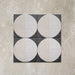 Kasuf Night 20x20cm terrazzo-style decor tiles featuring a bold monochrome circular pattern with speckled terrazzo detailing, ideal for creating statement floors and contemporary geometric interiors.