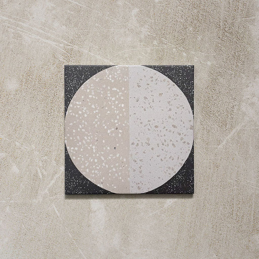 Kasuf Night 20x20cm terrazzo-style decor tiles featuring a bold monochrome circular pattern with speckled terrazzo detailing, ideal for creating statement floors and contemporary geometric interiors.