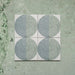 Kasuf Verde 20x20cm terrazzo-style decor tiles featuring a soft sage green and pale blue circular pattern with speckled terrazzo detailing, perfect for creating calming geometric floors and contemporary statement interiors.
