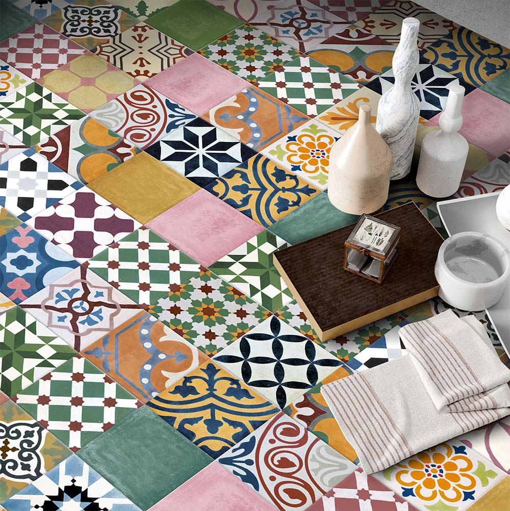 Marketing setting featuring Fihrdos Mini Patchwork Moroccan-style 15x15cm patterned porcelain floor tiles, showcasing a vibrant mix of colourful geometric designs styled with decorative accessories.