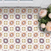 Cabana Manzanillo 20x20cm Moroccan-style porcelain tiles in a geometric star pattern featuring blush pink, mustard, terracotta, lilac, and turquoise tones with a matt finish, styled in a bright floral interior setting.