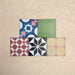 Fihrdos Mini Patchwork Moroccan-style 15x15cm patterned porcelain tiles arranged in a grouped layout, showcasing a mix of colourful geometric and traditional decorative designs.