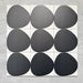 Pebble Beach Reversed Black 20x20cm patterned tiles featuring a bold black organic circular design, ideal for creating striking monochrome floors and statement walls with a contemporary geometric aesthetic.