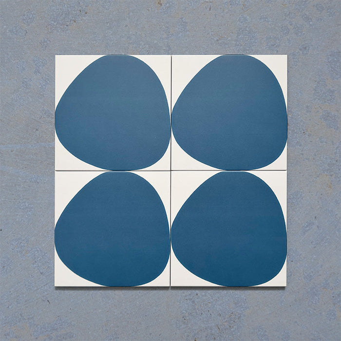 Pebble Beach Reversed Blue 20x20cm patterned tiles featuring a bold deep blue organic circular design, ideal for creating playful statement walls and contemporary patterned floors with a modern geometric feel.