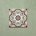 Cabana Paradise 20x20cm Moroccan-style ceramic tile shown as a single piece, featuring a multicolour floral pattern with pink, green, and mustard tones on a soft green background.