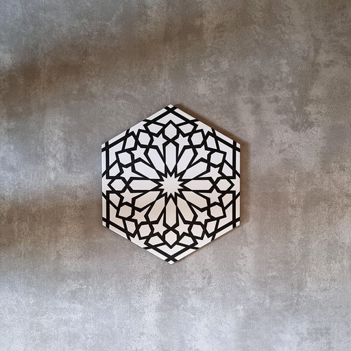 Imagen de producto del azulejo cerámico de estilo marroquí Alhambra Hexagon 18,7x21,6 cm, con patrón geométrico de estrella en blanco y negro en formato hexagonal, apto para pared y suelo.