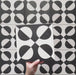 Geometry Illusion Noir 20x20cm geometric patterned tile with black and cream semicircles arranged in a bold symmetrical motif.