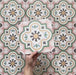 Cabana Paradise 20x20cm Moroccan-style ceramic tile shown as a single piece, featuring a multicolour floral pattern with pink, green, and mustard tones on a soft green background.