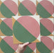 Geometry Paloma 20x20cm geometric patterned tile with pink and green semicircles and mustard and cream corner details.