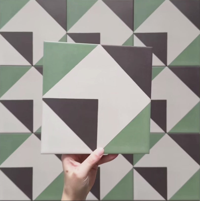 Geometry Angles Patterned Tile in 20cm x 20cm, featuring a modern geometric design with green, white, and black triangular shapes arranged to form a diamond motif.