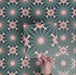 Single Fizaan Festive Blue 20x20cm Moroccan-style porcelain tile featuring an intricate geometric pattern in blue, green and soft neutral tones.